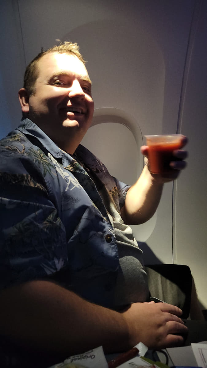 Mickey Wagner smiling while seated on an airplane